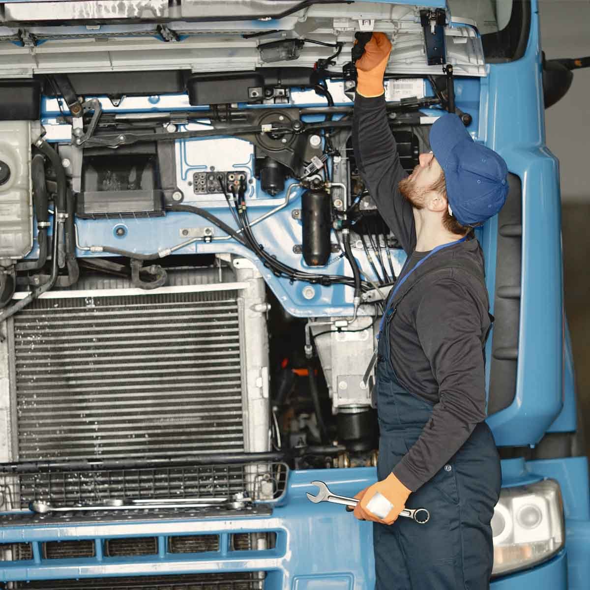 worker-checks-quality-of-truck-in-garage-in-unifor-2026-03-17-00-40-58-utc